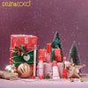 Kevin & Coco Winter Whisper Lip Set – holiday gift scene with lip products and Christmas trees